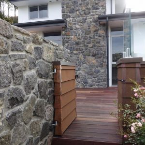 Rock wall with a gate beside