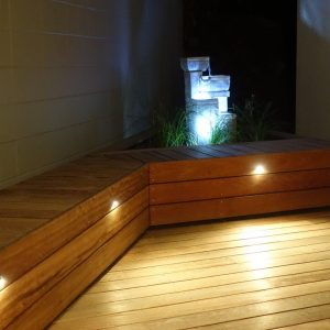 Deck with raised seat with landscaping planter box