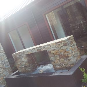 Water Feature Statement Piece with landscaping and garden beside