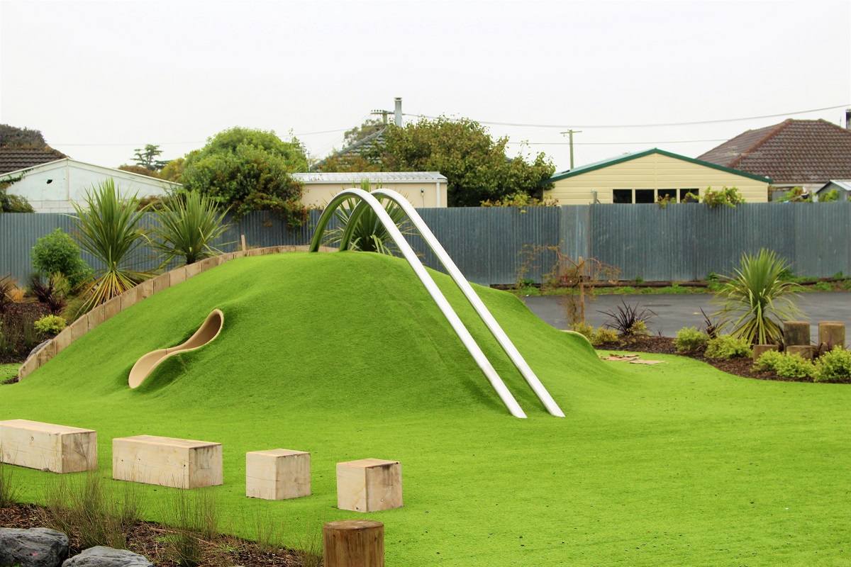 Grass landscaping design combined with a modern playground.