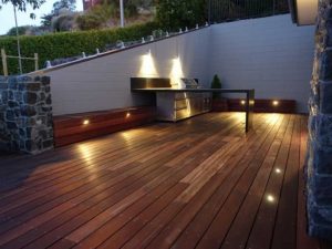 A backyard with a stunning wood decking hardscapes design.